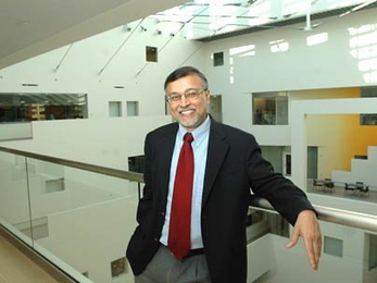 Mriganka Sur, head of the Department of Brain and Cognitive Sciences, stands on a balcony overlooking the 90-foot atrium inside the new Brain and Cognitive Sciences Complex, which will be officially dedicated on Friday, Dec. 2.