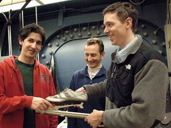 Seniors David Walfisch, left, and Kieran Culligan recently tested out a skate design that features a slider on a pivoting blade. Their advisor Kim Blair, director of the MIT Center for Sports Innovation, is at center.