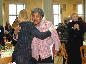 Donna Brazile embraces MIT President Susan Hockfield at the Martin Luther King Jr. breakfast.