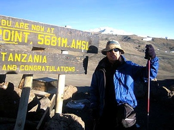 Graduate student Christopher Lowell, who went to Africa as part of Sloan's Global Entrepreneurship Laboratory, takes in the sunrise at Gilman's Peak in Tanzania. He eventually made it to the summit of Mount Kilimanjaro with G-Lab partner Zhiying Jiang.