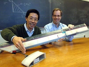 Professors Yet-Ming Chiang, left, and Steven Hall show components of their electrochemically actuated morphing rotor prototype (foreground) as well as a reduced-scale model (background) of a previous technology that uses piezoelectrics as the active materials.