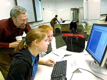 Professor of biology Graham Walker watches two Holliston High School students -- Hannah Cohen, left, and Kristen Mirageas -- explore the PDBViewer in the TEAL classroom in the basement of the Stata Center on Friday, March 31.