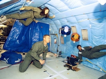 MIT's SPHERES mini satellites rocketed into space on Monday, April 24, en route to the International Space Station. The SPHERES team tested the satellites in 2004 aboard a NASA plane used to simulate weightlessness. From left are team members Stephanie Chen, Steve Sell and Edmund Kong.