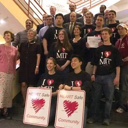 Community members display road signs that MIT received from the Metro Boston Emergency Medical Services Council on May 10. The signs, which will be installed on Massachusetts Avenue, reflect MIT's designation as the first HeartSafe college in the country.