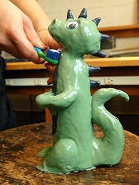 'Flosszilla,' created in Toy Product Design seminar, squirts toothpaste from its mouth and dispenses floss from its tail.