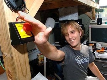 Freshman R.J. Ryan hits the 'emergency' button in his automatic dorm room on East Campus. The button activates 'party mode.'