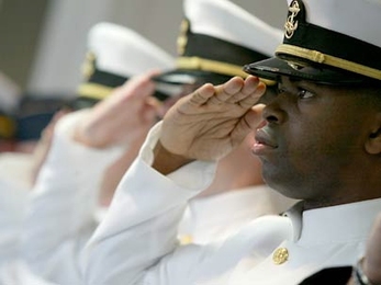 New MIT graduate and naval officer Piko A. Neal salutes the flag during the ROTC commissioning ceremony held Friday, June 9, at the U.S. Coast Guard Station in Boston.