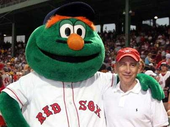 MIT Institute Professor Robert Langer poses with Red Sox mascot Wally the Green Monster before throwing out the ceremonial first pitch at Fenway Park on July 28.