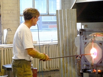 Peter Houk, technical instructor and glass artist in the MIT Glass Lab, shapes a piece that will model color for students of the lab.
