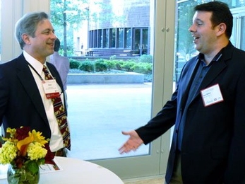 Dean Calcagni, HST advisory council member, left, chats with Sean McKee, Pharma Biosante, at the 5th annual BioBash.