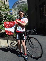 Graduate student Sonya Cates displays one of the MIT cycling team's jerseys that will be auctioned off on eBay to help support the team. The shirt was signed by four MIT Nobel laureates and the winner of the 2003 Turing Award.