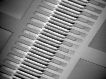 This micropump developed by MIT researchers allows high speed flows through microchannels with an input of only a few volts of electricity, making it possible to create portable "lab on a chip" devices.
The three-dimensional, alternating current electro-osmotic pump consists of interdigitated stepped gold microelectrodes on a glass substrate.