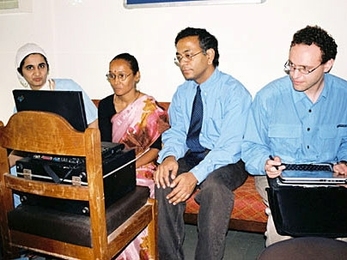 MIT researchers Pawan Sinha, center, and Yuri Ostrovsky, right, test the visual skills of a patient in India. The patient, known as S.R.D., had her vision restored at the age of 12.