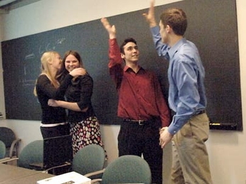 Biodiesel@MIT first-year students Katie Rowe, left, and Katrina Ellison embrace while junior Joe Roy-Mayhew, left, and senior Matt Zedler high-five. The group had just learned they had won the national Ecomagination Challenge for their initiative to turn used vegetable oil into biodiesel fuel for MIT campus vehicles.