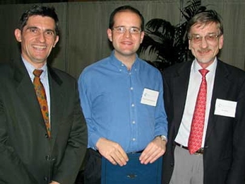 Professor Patrick Jaillet (left), head of the Department of Civil and Environmental Engineering, and Professor Ole Madsen (right) of CEE present the Maseeh Award for excellence as a teaching assistant to CEE graduate student David Gonzalez Rodriguez.