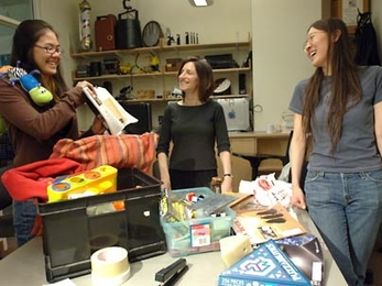 MIT student Lisa Nakano, left, a senior in brain and cognitive sciences; Ruth Rosenholtz, principal research scientist; and graduate student Yuan Zhen laugh at the clutter in an office. The three have identified a way to measure visual clutter.