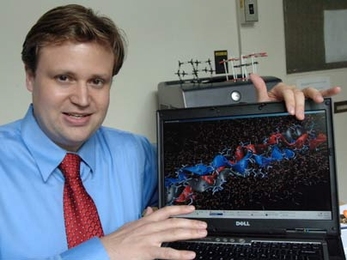 MIT Professor Markus Buehler has helped reveal why bones are so tough.  The object on the screen is a triple helical tropocollagen molecule, a fundamental building block of bone. Next to the molecule are nanosized hydroxyapatite chalk-like crystals. In his work he simulates the behavior of the composite of tropocollagen and hydroxyapatite during deformation.
