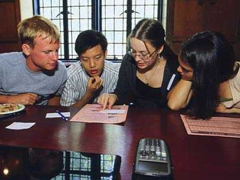 Left to right, freshmen Ian Tracy, Tung Shen Chew, Hannah Farrow and Melissa Diskin develop their strategy for conquering the fishing industry in the FishBanks game, part of a preorientation session last month.