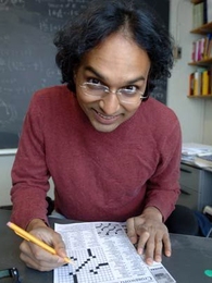 Math professor and crossword puzzle fiend Kiran Kedlaya works on Friday's New York Times puzzle. He will compete in the American Crossword Puzzle Tournament on Feb. 29.