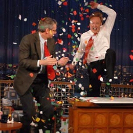 MIT Professor Peter Fisher celebrates with NBC's Conan O'Brien dur-ing an episode that aired in early February. Fisher, who helped the comedian spin his wedding ring on his desk for 51 seconds, is one of many MIT professors hitting the airwaves recently.
