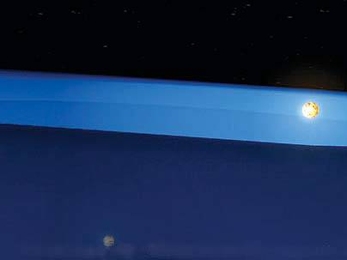 The unusual geometry of this star system made it possible for researchers to discover the first evidence of the middle stages of planet formation. Above, one star rises above the obscuring disk of matter, and its light becomes visible.