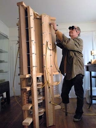 MIT biology research affiliate Joe Davis works in his apartment in Cambridge on the prototype for a Hurricane Katrina memorial--a 109-foot tower that will send laser beams into the sky. He recently won a Rockefeller fellowship for the project.