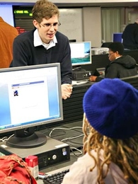 MIT undergraduate Randy Shults, top left, a coordinator for the volunteer organization Families Accessing Computer Technology, works with one of the program's clients, Nicole Doctor, bottom.