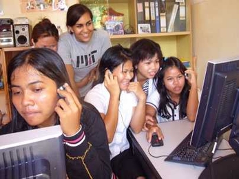 MIT junior Shirin Kasturia works with women in Cambodia
  after giving them donated computers and teaching them basic computing skills.