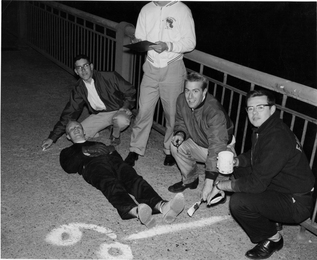 Alumnus Oliver Smoot "62 is used to measure the Massachusetts Avenue bridge in 1958.