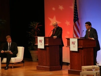 Representatives from the two presidential campaigns, R. James Woolsey, center, for Senator John McCain, and Jason Grumet for Senator Barack Obama, face off in a debate on energy policy held Monday night in Kresge Auditorium at MIT. NPR's Tom Ashbrook, left, moderated the debate.