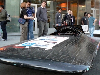 Visitors to Energy Night at the MIT Museum examine the Solar Electric Vehicle Club's original car, which will soon be replaced by a newer version.