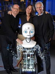 David Kirkpatrick (left), Chairman of Plymouth Rock Studios, Cynthia Breazeal, co-director of Media Lab's Center for Future Storytelling, and Frank Moss, director of the MIT Media Lab, with Nexi, a mobile,  dexterous social robot developed by Breazeal's Personal Robots research group.