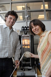 Mechanical Engineering Professor Anette Hosoi and graduate student Amos Winter developed a robo-clam that could lead to "smart" anchoring technologies. Outside the testing device they hold clamshells of some of the clams they tested.