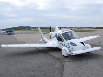 The TransitionÂ® Roadable Light Sport Aircraft Proof of Concept with wings extended at Lawrence Municipal Airport.