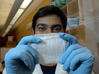 Sophomore Asad Moten holds up a fibrous scaffold he developed that can help regenerate cartilage and other tissues.