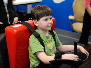 A young stroke patient tests out an MIT-developed robotic therapy device at Blythedale Children's Hospital in Westchester County, N.Y.