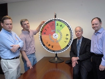 Ronald Prinn, director of MIT's Center for Global Change Science, and his group have revised their model that shows how much hotter the Earth's climate will get in this century without substantial policy change. Standing with the group's "roulette wheel" are, from left to right, Mort Webster, professor in the Engineering Systems Division; Adam Schlosser, principal research scientist at the Center ...
