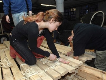 Students from Professor of Archeology and Ancient Technology Dorothy Hosler's class work on making  the full-size authentic replica of a pre-Columbian South American balsa oceangoing raft on the Charles river. Here Leslie Dewan and Feng Wu work.