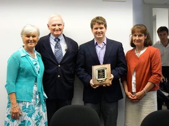 Jeremy Stewart, LFM '10, center, winner of the 2009 Charles "Harrison" Smith Award, with Harrison's family. From left to right: Â Sandra Smith, mother; Charles Smith, father; Stewart (holding award); and Sandy Story, sister.