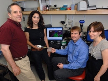 Professor Elazer Edelman, Natalie Artzi, Aaron Baker and Adriana Bon in the lab with a surgical adhesive they have developed.