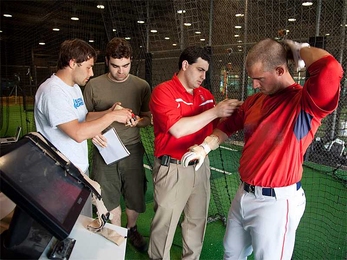 A player at the Boston Red Sox preseason training camp is wired with sensors developed by the MIT Media Lab, which gauge the forces he exerts when he swings the bat.
