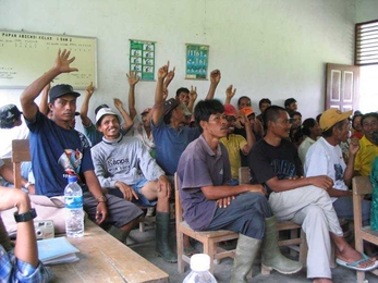 Indonesian village residents participating in a field experiment on direct democracy.