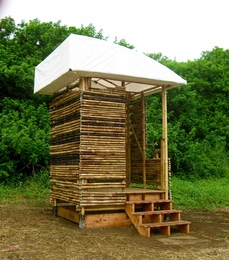 The completed H3 (Hawaii Hygiene Hut) designed for the cluster housing project. The team tested design principles such as the use of bamboo for the structure and fabric for the roof.