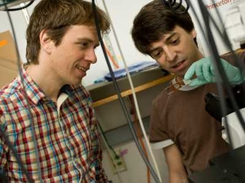 Physics Professor Alexander van Oudenaarden, left, works in his lab with physics graduate student Bernardo Pando.