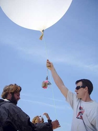 Stewart Long (right) prepares to launch a balloon-mounted camera from the Chandeleur Islands in Louisiana.