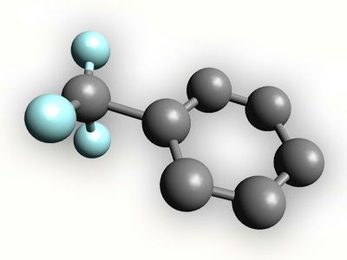 In this model, trifluoromethyl is attached to a ring of six carbons (known as a benzene ring). The gray balls represent carbon atoms, and the blue balls represent fluorine. (Hydrogen atoms attached to the benzene ring are not shown.)