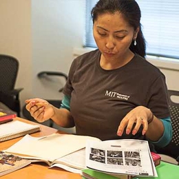 Tsering Mulug-Labrang, a Department of Facilities custodian who was born in India, reviews an assignment during a recent English as a Second Language (ESL) class.
