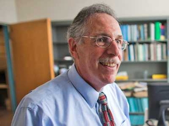 Economist Peter A. Diamond takes phone calls and relaxes in his office after a press conference announcing that he, and two others, were awarded the Nobel Prize in Economics Monday.
