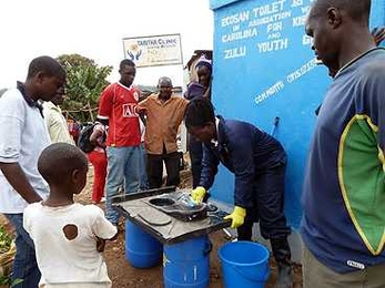 Community members attend a training session to learn how to keep the new Sanergy pilot toilets spotlessly clean.
