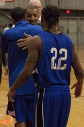 Larry and Paul Anderson embrace as the teams shake hands at the end of the MIT-UMass game in Rockwell Cage last Tuesday night.